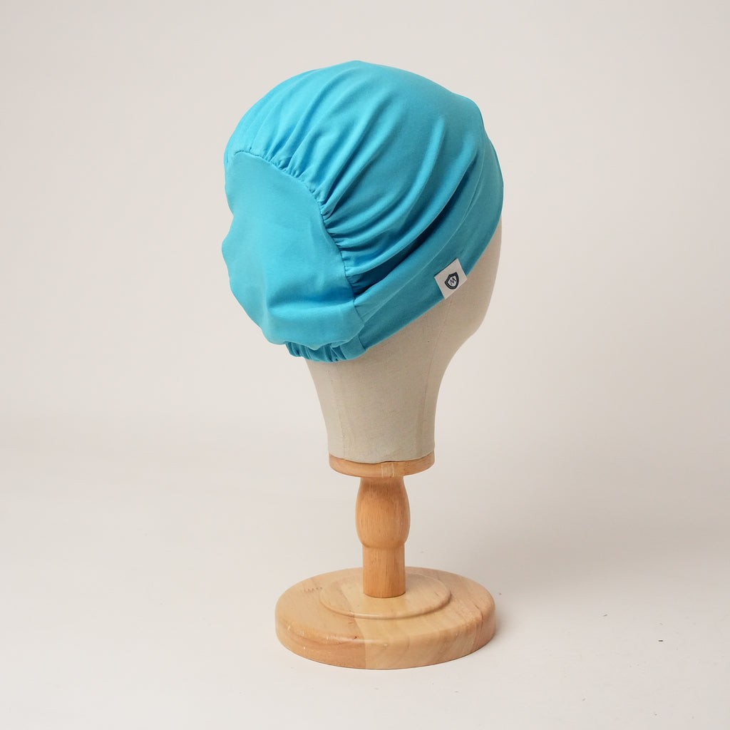 Contour stretch scrub cap in cyan, back view