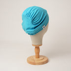Contour stretch scrub cap in cyan, back view