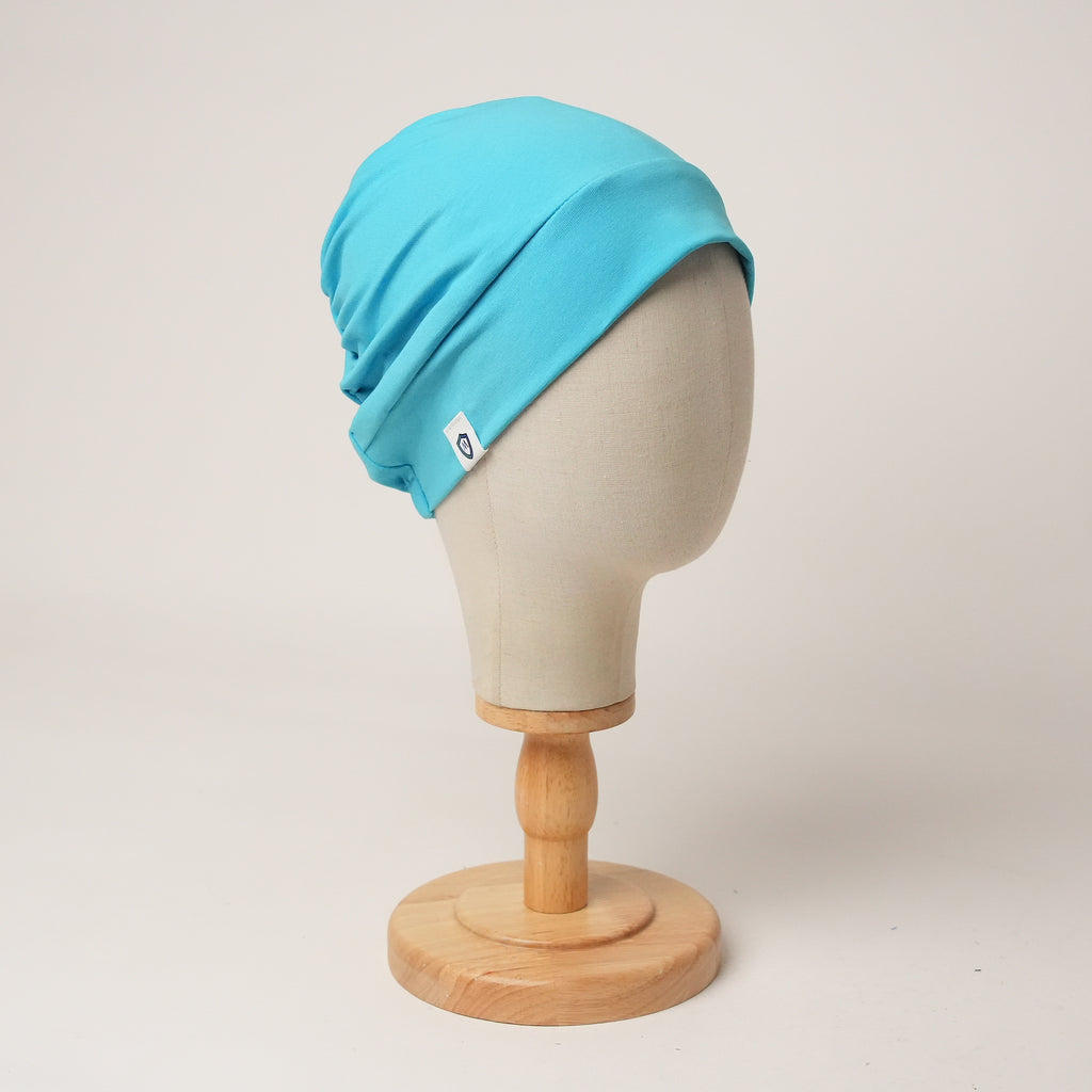 Contour stretch scrub cap in cyan, front view