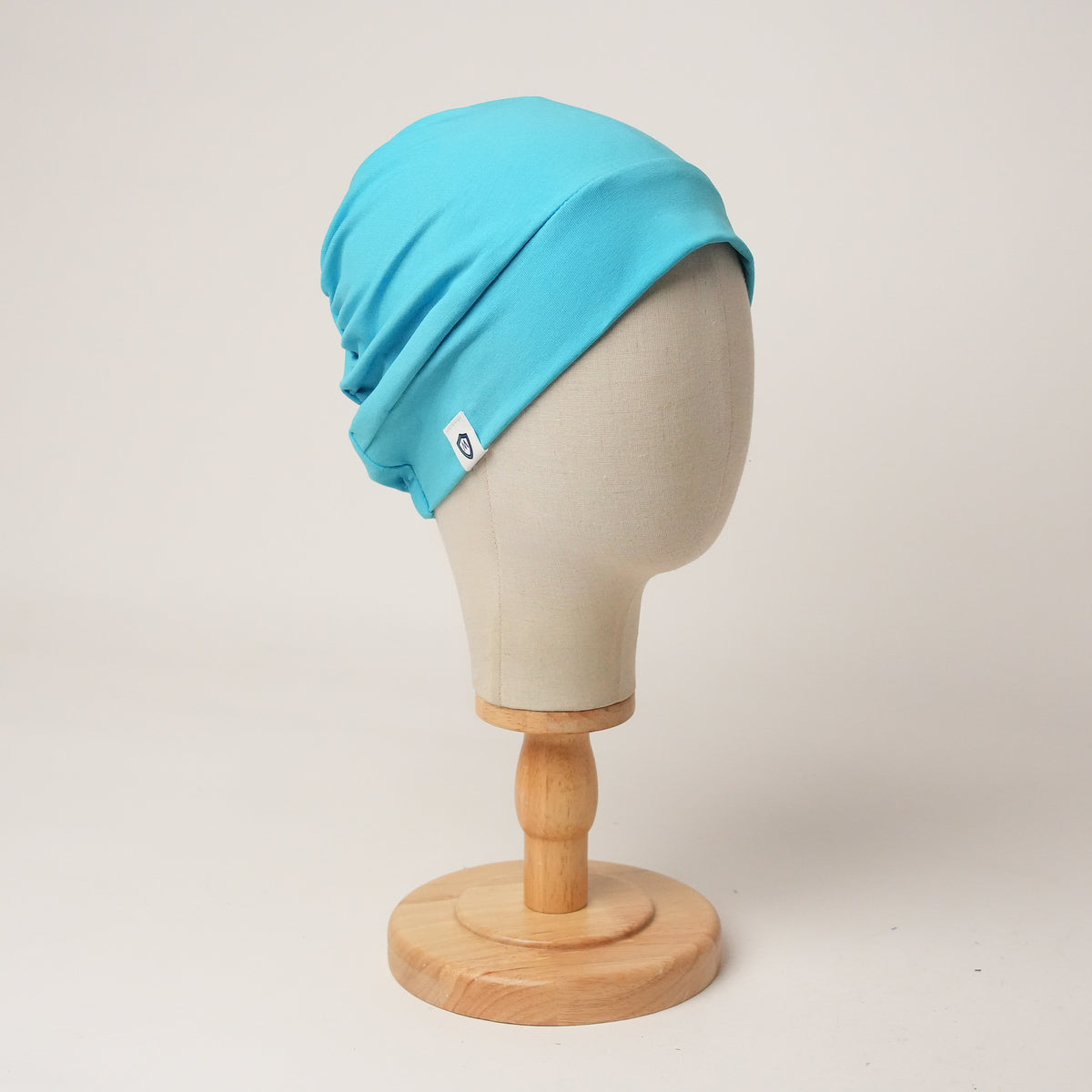 Contour stretch scrub cap in cyan, front view