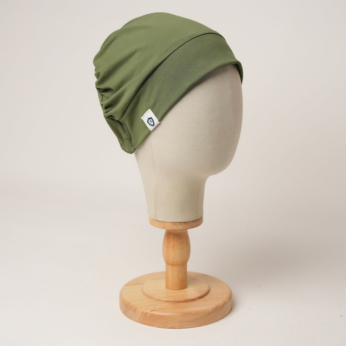 Contour stretch scrub cap in olive, front right view