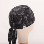 Dinosaur Bones Cartoon Dark scrub cap shown on mannequin head