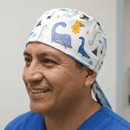 Dinosaurs Purple Blue Orange scrub cap shown on model