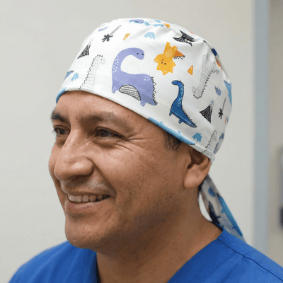 Dinosaurs Purple Blue Orange scrub cap shown on model