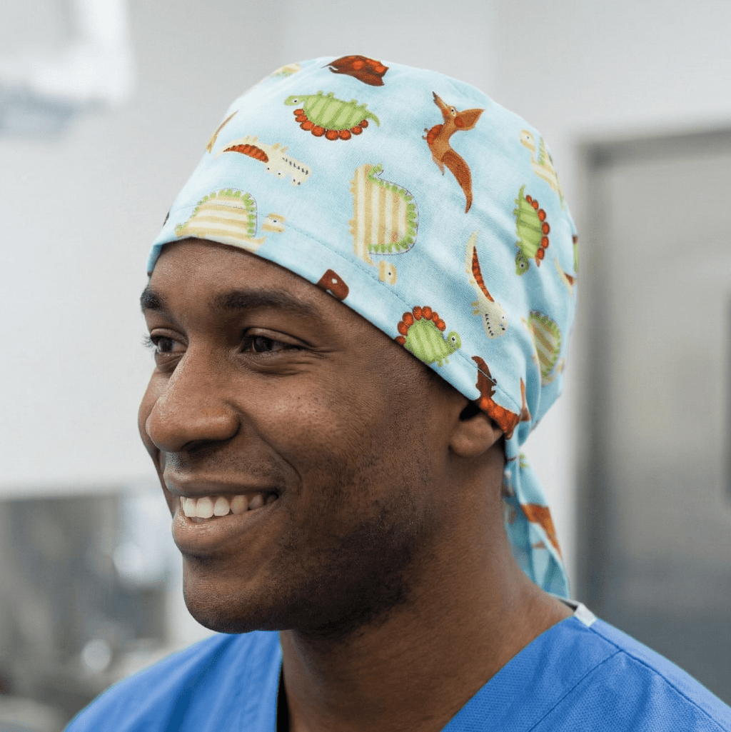 Dinosaurs in a Swamp Light Blue scrub cap shown on model