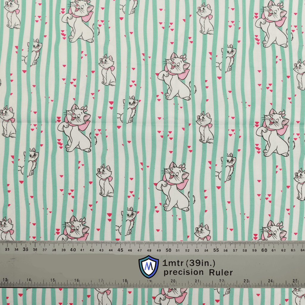 Fabric sample for Medicus Scrub Caps featuring Disney Marie Cat print with green stripes and hearts, shown with a ruler for scale.