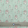 Fabric sample for Medicus Scrub Caps featuring Disney Marie Cat print with green stripes and hearts, shown with a ruler for scale.