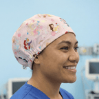 Disney Princesses Mashup Pink scrub cap shown on model