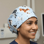 Dog Toss On Light Blue scrub cap shown on model