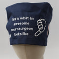 Navy blue Medicus Scrub Cap with white embroidery reading "This is what an awesome neurosurgeon looks like" alongside a pointing hand design.