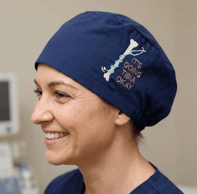 Embroidery - Its Going Tibia OK scrub cap shown on model