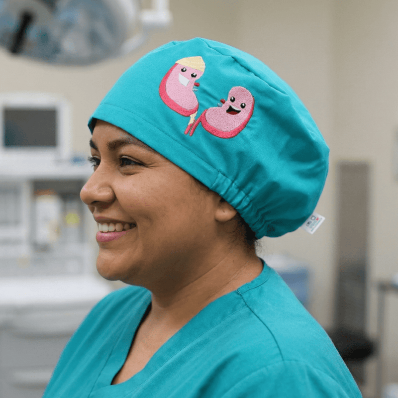 A scrub cap with a kidney design embroidered on the front