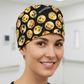 Person wearing a black scrub cap with emoji patterns in a medical setting
