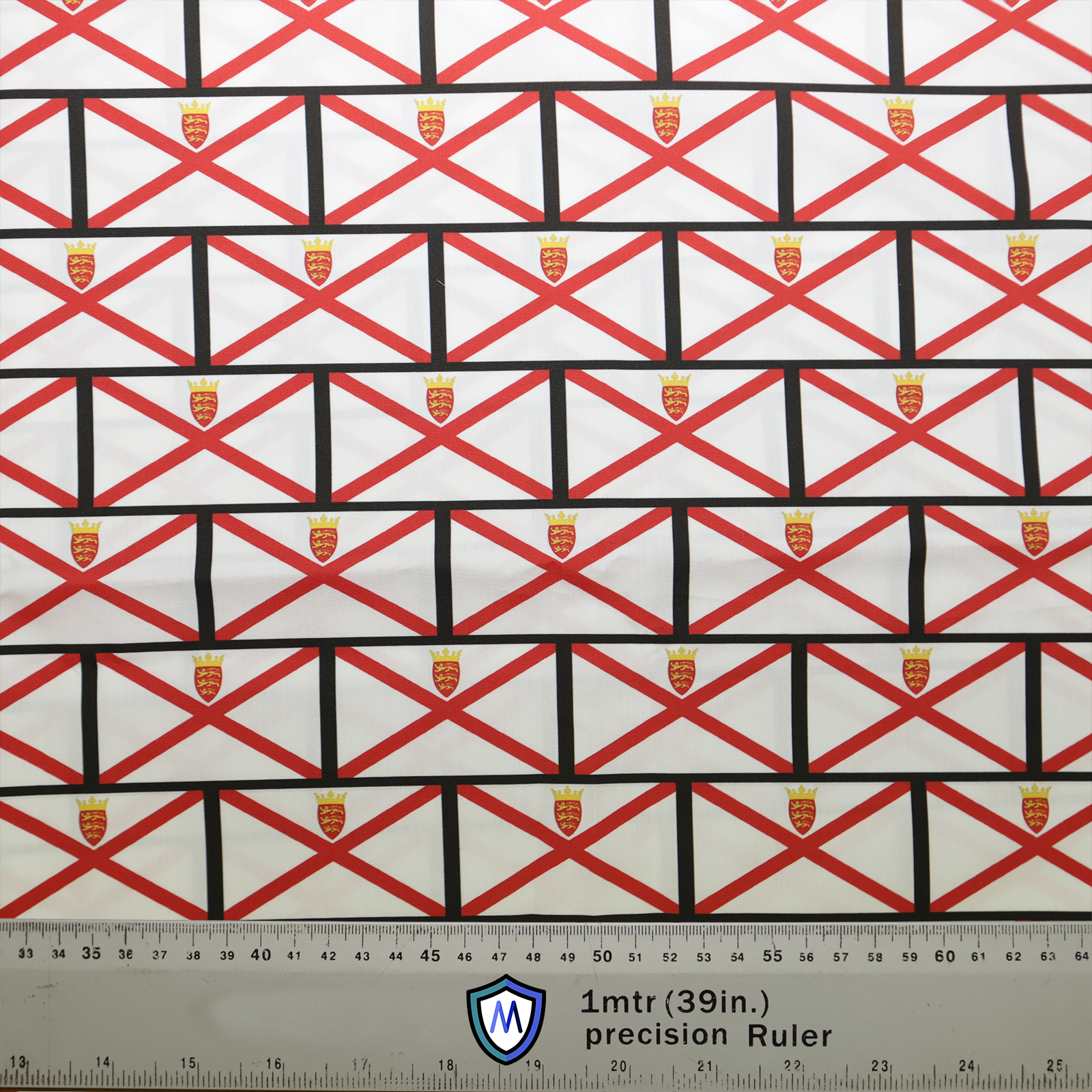 The Flag Jersey Island Scrub Cap by Medicus Scrub Caps features a red and black X pattern with crests, made from eco-friendly fabric, with a ruler for scale.