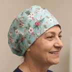 Floral On Teal scrub cap shown on model