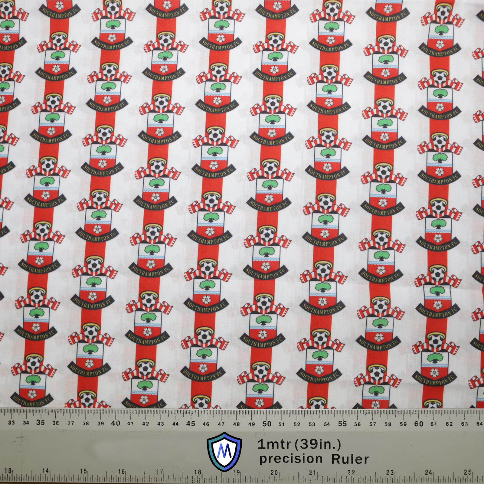 Patterned fabric featuring repeated Southampton FC logos in red, white, and green, ideal for Medicus Scrub Caps. A ruler at the bottom shows scale.