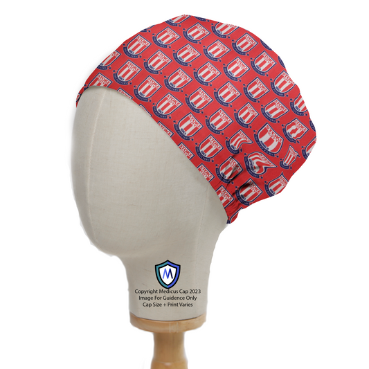 A mannequin head wears a Football Club Stoke City FC Scrub Cap by Medicus Scrub Caps, featuring club logos on a red background. Eco-friendly design.