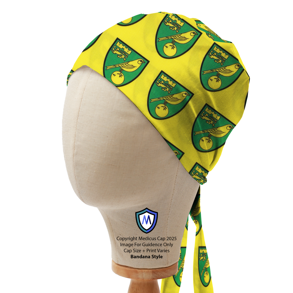 Mannequin head wearing a yellow Medicus Scrub Cap with multiple Norwich City FC crests in green and gold, bandana style.
