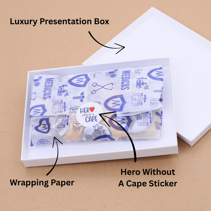 A scrub cap wrapped in tissue paper inside a white gift box