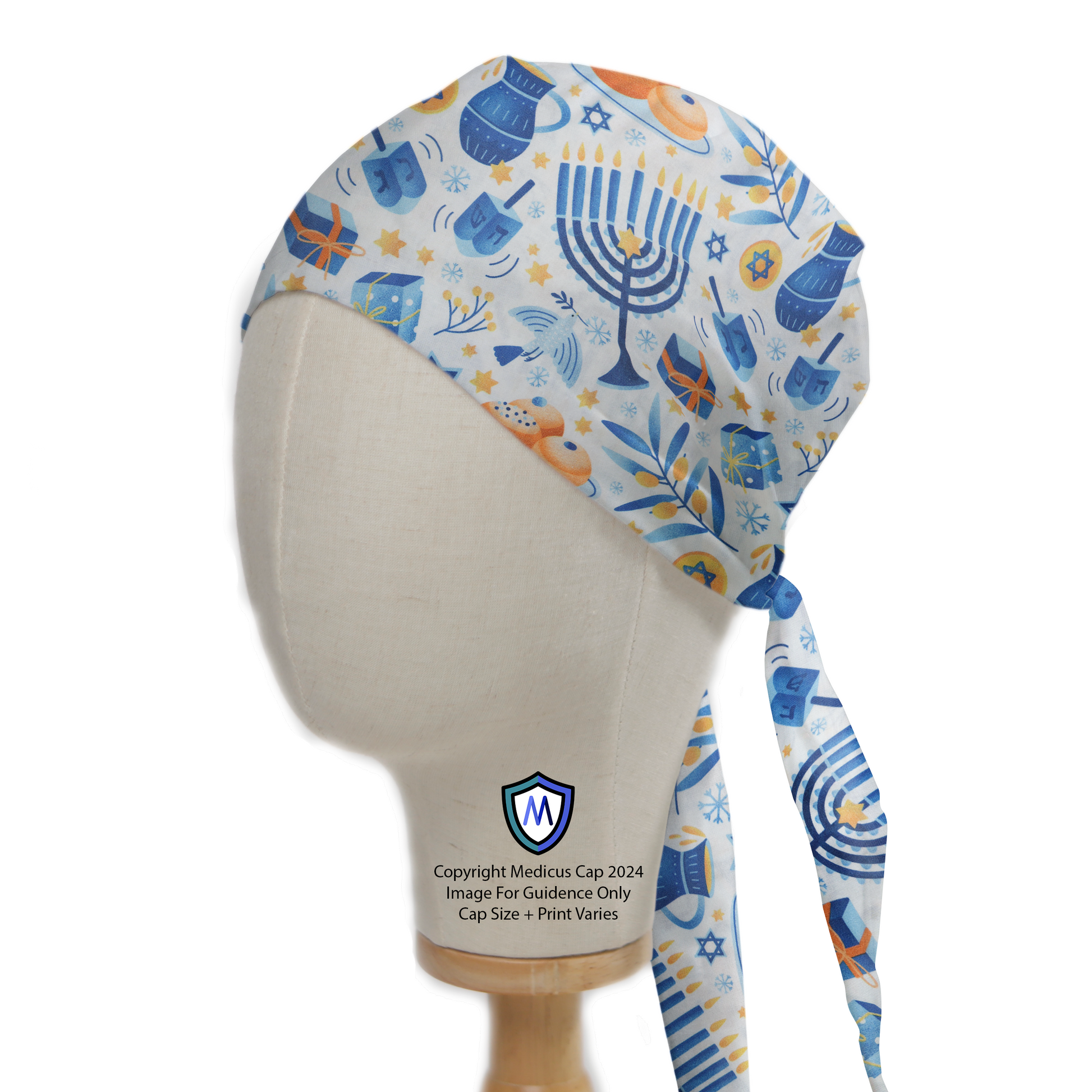 A mannequin head displays a Hanukkah Celebrations Trinkets Scrub Cap by Medicus Scrub Caps, featuring menorahs, dreidels, and festive symbols in blue and orange.