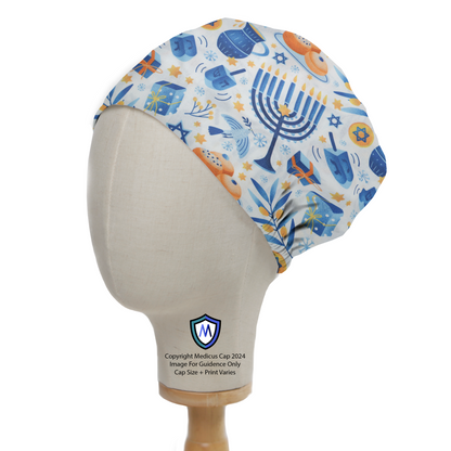 A mannequin head models the Hanukkah Celebrations Trinkets Scrub Cap by Medicus Scrub Caps, featuring menorahs, dreidels, and festive symbols in blue and white.