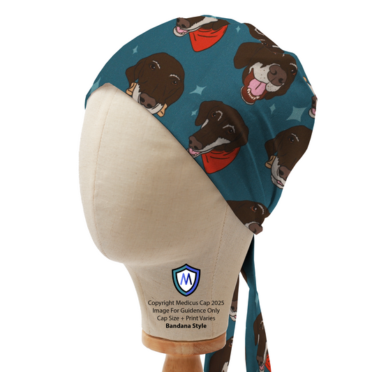 A mannequin head wears the Happy Dog Neckerchief Scrub Cap by Medicus Scrub Caps, featuring smiling brown dogs with red bandanas on a teal background.