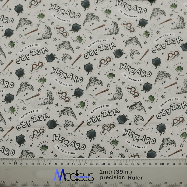 Close-up of Harry Potter Wizard In Training fabric for Medicus Scrub Caps, featuring wands, owls, cauldrons, and text, perfect for wizarding fans.
