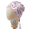 Bandana style scrub cap featuring Hello Kitty in a pink rose garden pattern with bows, shown on mannequin side view.