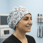 Hello Kitty Scrub Cap on model wearing blue Hello Kitty design with rainbows and stars