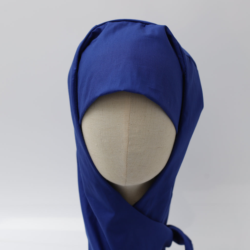 Blue Medicus hijab scrub cap on a mannequin, designed for comfort and coverage. Reusable and ideal for theatre use.