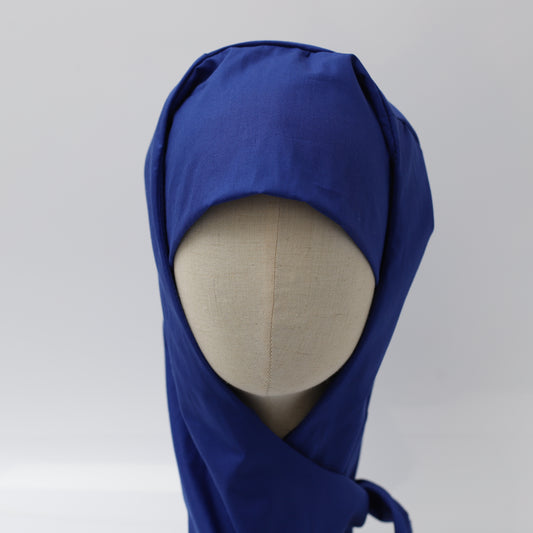 Blue Medicus hijab scrub cap on a mannequin, designed for comfort and coverage. Reusable and ideal for theatre use.