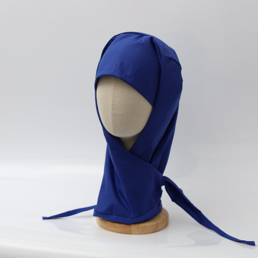 Blue Medicus hijab scrub cap on a mannequin, designed for medical professionals. Reusable theatre hat with full coverage and tie-back closure.