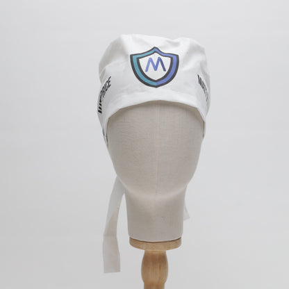 A mannequin head displays the Medicus Scrub Caps Specific Custom Printed Placement Scrub Cap, featuring a white design with an "M" logo and side text.