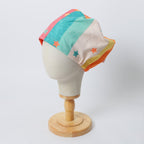 90s Stars Rainbow scrub cap shown on mannequin head