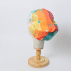 90s Stars Rainbow scrub cap shown on mannequin head