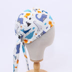 Dinosaurs Purple Blue Orange scrub cap fabric pattern close-up