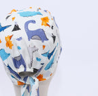 Dinosaurs Purple Blue Orange scrub cap pattern detail on mannequin