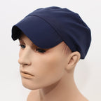 Navy blue scrub cap with curved peak shown in side profile view on mannequin head