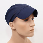 Navy blue scrub cap with structured peak shown in side profile view on mannequin head