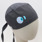 Gray scrub cap with blue eye design vinyl transfer shown on mannequin head side view