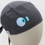 Close-up detail of gray scrub cap featuring blue eyeball vinyl transfer design