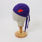 Purple scrub cap with red liver design shown on white mannequin head, side view