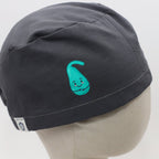 Dark gray scrub cap with turquoise teardrop character design, side profile view