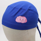 Blue scrub cap with pink smiling brain design shown on mannequin head front view