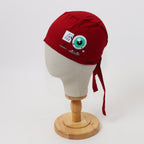 Red scrub cap with eye chart design and eyeball graphic shown on mannequin head side view