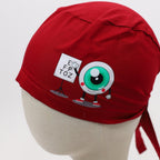 Red scrub cap with cartoon eyeball character and "EYE LOVE TOZ" design shown on head form