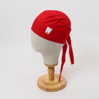 Red scrub cap with white sparkle tooth design shown on mannequin head side view