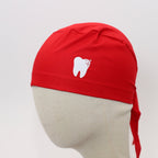 Red scrub cap with white sparkle tooth design shown on mannequin head front view
