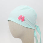 Mint green scrub cap with pink cartoon kidneys design shown on mannequin head side view