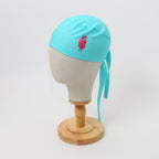 Turquoise scrub cap with red heart vinyl design shown on mannequin head side view